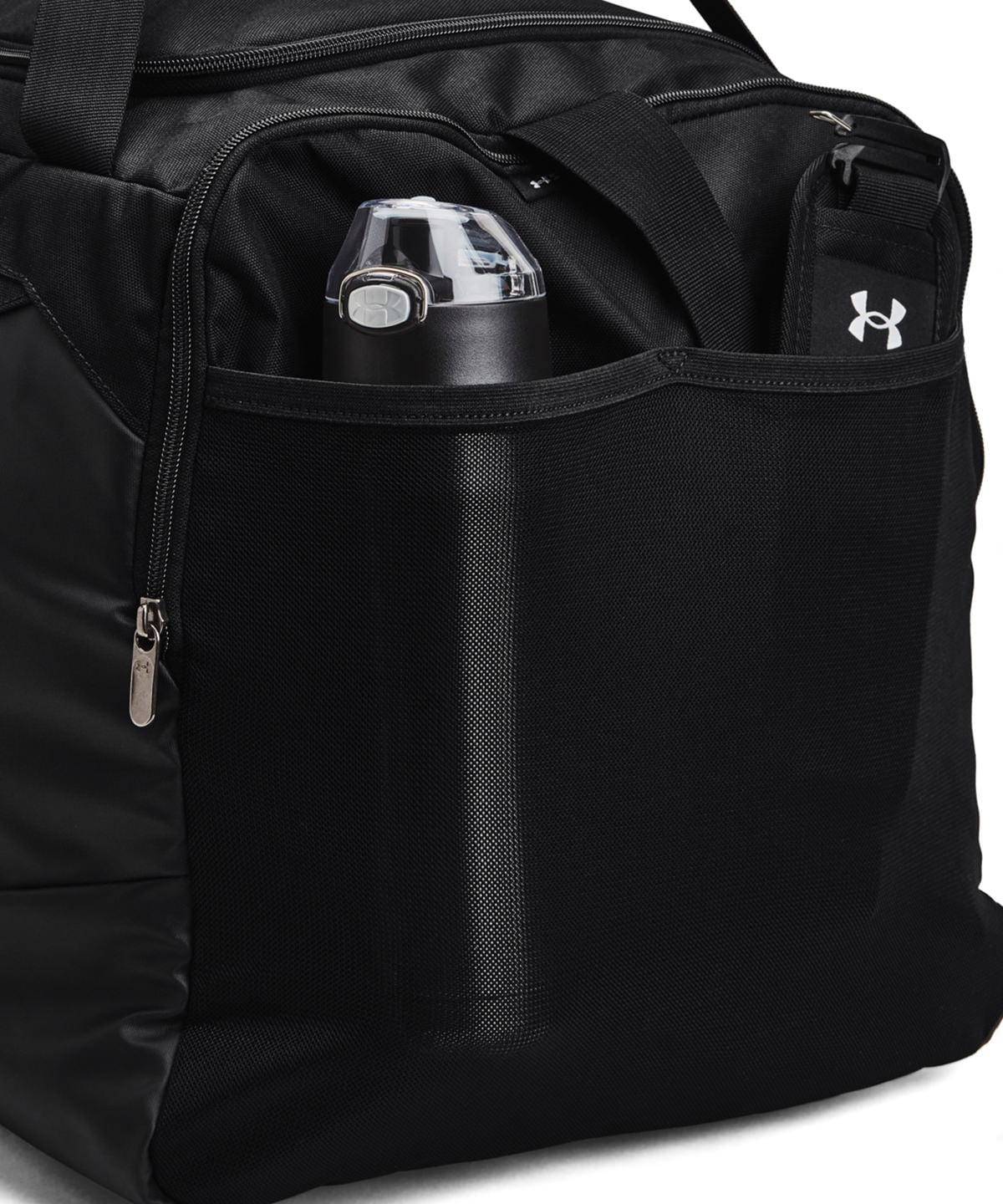 Black Under Armour duffel bag with multiple zippered compartments and a side pocket featuring the white Under Armour logo, shown close-up with a water bottle in the top pocket.