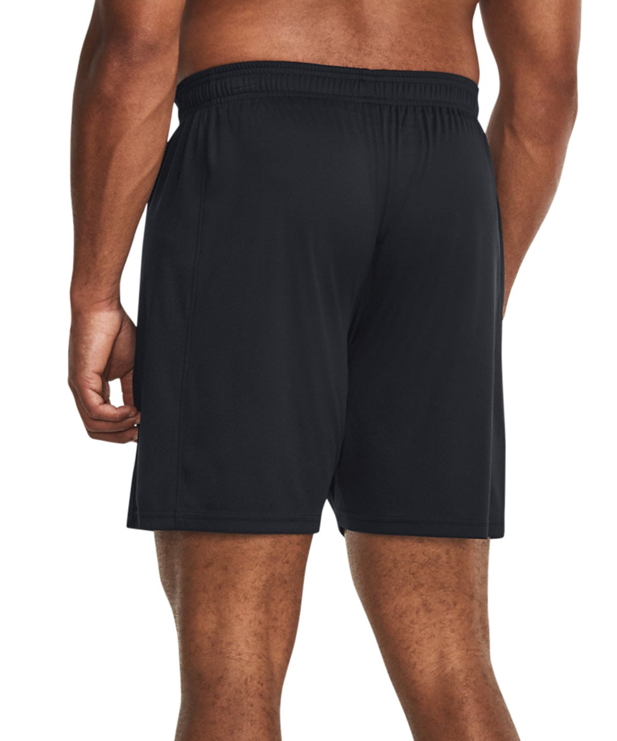 Rear view of a man wearing black athletic shorts against a plain white background.